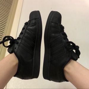 All black Adidas Originals Superstar sneakers